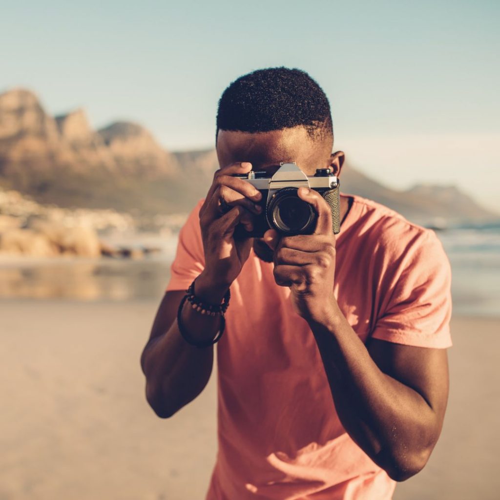 young black man with camera
